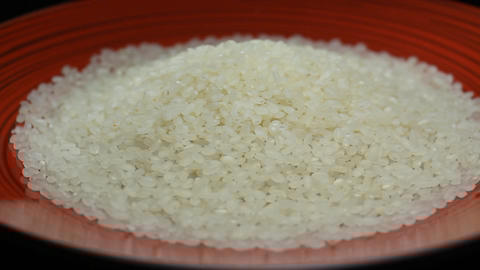 Handful of Rice on a Red Plate Rotating